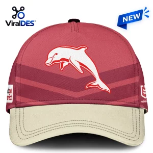 Front view of a red baseball cap featuring a white dolphin graphic and 2026 NRL-inspired design elements.