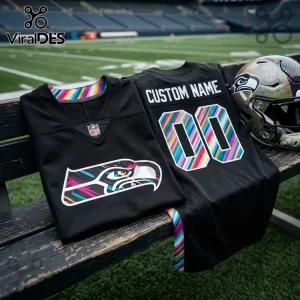 Seattle Seahawks 2026 Crucial Catch black football jersey featuring multicolored striped accents and team logo on a bench.