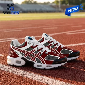 Side view of maroon and white personalized Alabama A&M Bulldogs sneakers on a red running track.