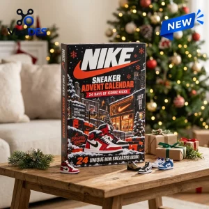 Front view of Nike Advent Calendar 2026 box with miniature sneaker models on a wooden table near a decorated holiday tree.