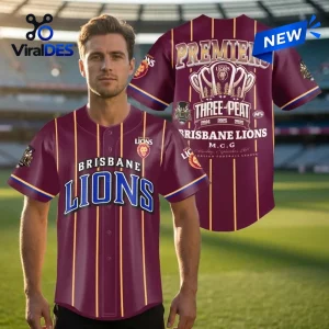 Man wearing the Brisbane Lions Maroon Three-Peat Baseball Jersey on a stadium background.