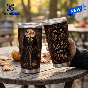 Two witch sisters Halloween custom name tumblers held on a wooden table with a spooky moon and castle illustration.