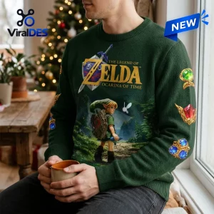 Front view of a green knit sweater featuring a video game character, a sword graphic, and various gemstone prints.