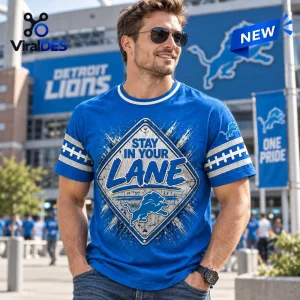 Front view of a man wearing a blue Detroit Lions t-shirt with a street sign graphic and football stripe sleeve details.