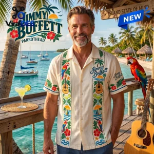 Man wearing a cream Guayabera Hawaiian shirt with tropical embroidery on a beach deck.