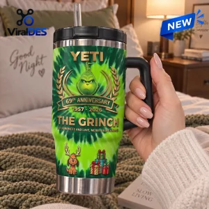 Hand holding green Yeti The Grinch 69th Anniversary handle tumbler with straw.