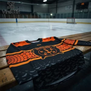 Norfolk Admirals 2026 Halloween Orange Black Hockey Jersey with spiderweb patterns and bat motifs on a locker room bench.