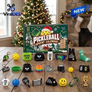 Front view of Pickleball Advent Calendar 2026 box with various sports accessories laid out on wood table.