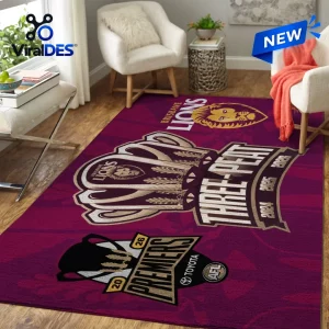 Angled view of the Brisbane Lions 2026 AFL Premiers area rug placed on a wooden floor in a living room.