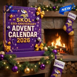 Front view of a purple Minnesota Vikings 2026 Advent Calendar decorated with gold bows and ornaments near a fireplace.