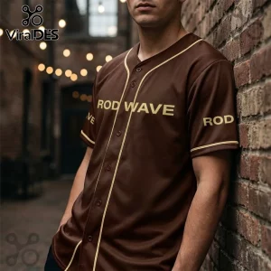 Rod Wave Don't Look Down Tour brown baseball jersey featuring gold lettering, buttons, and matching trim on a man.