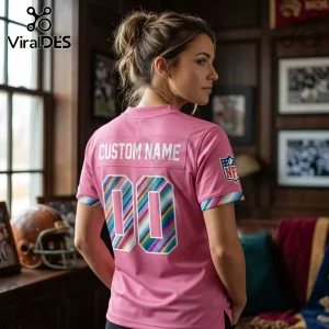 Philadelphia Eagles 2026 Crucial Catch Pink Football Jersey worn by a woman with striped multicolor numbers and team logo.