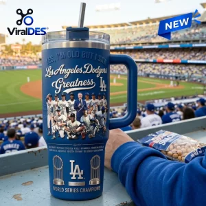 Front view of a blue Los Angeles Dodgers Stanley tumbler with baseball player graphics at a stadium.