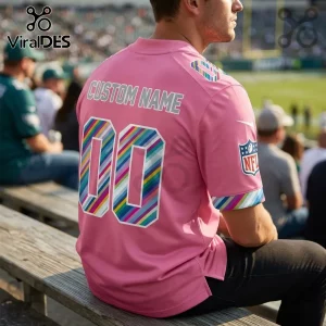 Philadelphia Eagles 2026 Crucial Catch Pink Football Jersey with rainbow striped numbers and NFL sleeve branding.