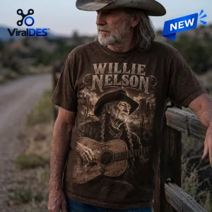 Front view of a brown Willie Nelson t-shirt featuring a man in a cowboy hat playing an acoustic guitar.