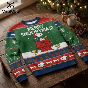Snoopy Merry Snoopymas Green Ugly Christmas Sweater featuring Snoopy, Woodstock, and holiday patterns on a wooden table.