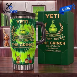 Front view of Yeti The Grinch 69th Anniversary Handle Tumbler with matching green gift box on a wooden surface.