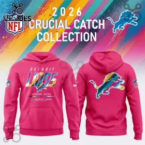 Detroit Lions 2026 Crucial Catch pink hoodie with front team logo and rear jumping lion graphic on a colorful background.
