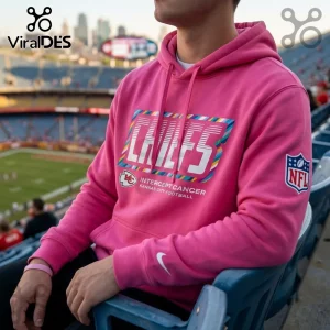 Kansas City Chiefs Crucial Catch Pink Pullover Hoodie with team logo and NFL branding worn in a stadium setting.