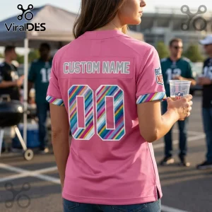Philadelphia Eagles 2026 Crucial Catch pink football jersey featuring custom name and rainbow striped number zero zero.
