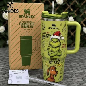 Stanley The Grinch Green 40oz Flowstate Tumbler featuring Grinch graphics, text, and a metal straw next to its retail box.