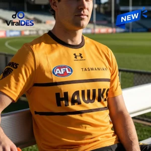 Hawthorn Football Club Gold Performance T-Shirt featuring brown horizontal stripes, team branding, and AFL logo on mesh fabric.