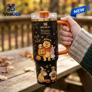 Hand holding a black 40oz tumbler featuring Halloween character graphics and Trick or Treat text.