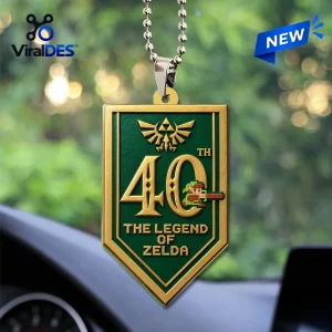 The Legend of Zelda 40th Anniversary Acrylic Car Ornament featuring a green shield with gold trim and pixel art detailing.