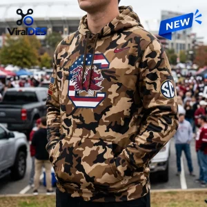 South Carolina Gamecocks Camo Military Appreciation Hoodie with American flag C logo and SEC patch on a fan at a stadium.
