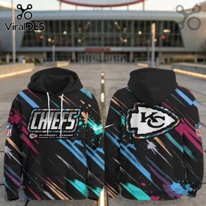 Kansas City Chiefs 2026 Crucial Catch black pullover hoodie featuring colorful paint splatter graphics and team logos.