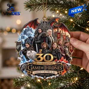 Hand holding a Game of Thrones 30th Anniversary Christmas ornament featuring a cast ensemble collage and a red dragon.