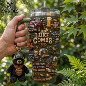 Luke Combs Embossed Green 40oz Tumbler with country music graphics, a truck, and matching bear keychain held outdoors.