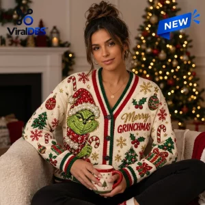 Front view of a person wearing a Grinch Christmas 2026 ugly cardigan with holiday motifs and red and green trim.