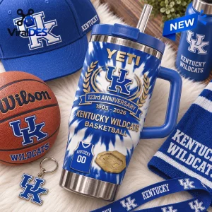 Close-up of a Kentucky Wildcats 123rd Anniversary Stanley Tumbler surrounded by a basketball, cap, and branded gear.
