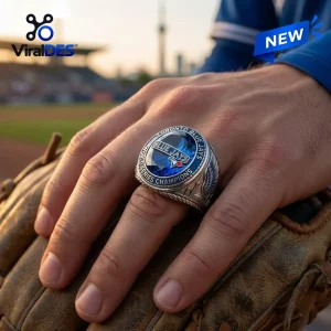 Closeup of a Toronto Blue Jays World Series Champions ring worn on a hand resting over a baseball glove.