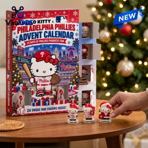 Front view of Hello Kitty x Philadelphia Phillies advent calendar with hand placing mini character figures on a table.