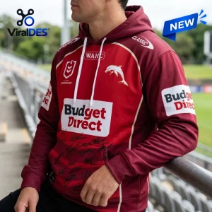 Close-up view of a person wearing a red Dolphins NRL 2026 hoodie featuring sponsor logos and signature graphics.