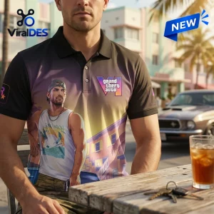 Front view of a person wearing a Grand Theft Auto VI Gradient Polo Shirt featuring character art and sunset scenery.
