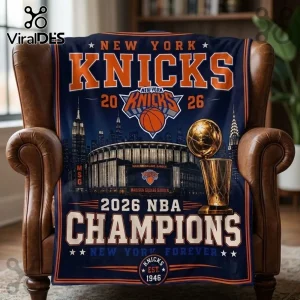 New York Knicks 2026 Champions navy fleece blanket featuring Madison Square Garden, a trophy, and team logo graphics.