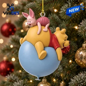 Close up of an acrylic ornament featuring a bear and a small pink creature on a blue balloon hanging on a tree.
