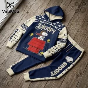 Snoopy Flying Ace navy blue hoodie jogger set featuring a red doghouse and cream accents on a wooden floor background.
