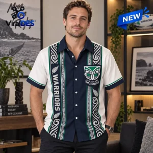 Man wearing a New Zealand Warriors Maori pattern Hawaiian shirt with a central navy stripe and white side panels.