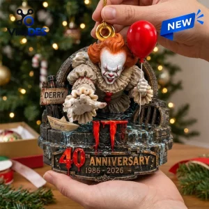 Hand holding an IT 40th Anniversary Pennywise Christmas ornament featuring the clown with a red balloon and sewer grate.