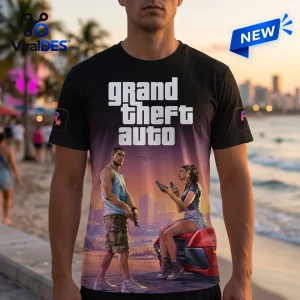 Front view of a person wearing a Grand Theft Auto VI Sunset T-Shirt with a beach and city graphic.