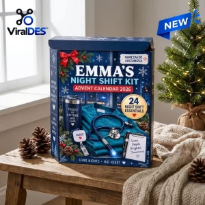 Front view of the Emma Night Shift Essentials Advent Calendar 2026 box with medical-themed gifts on a wooden table.