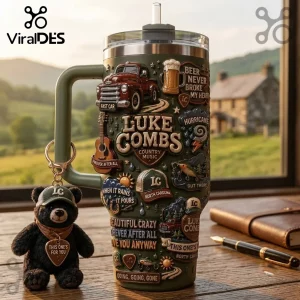 Luke Combs Embossed Green 40oz Tumbler with relief carvings of country music icons, a truck, and song lyrics on a desk.