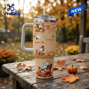 Snoopy Thanksgiving Fall Leaves 40oz Tumbler with cream finish, handle, straw, and Peanuts characters amid autumn foliage.