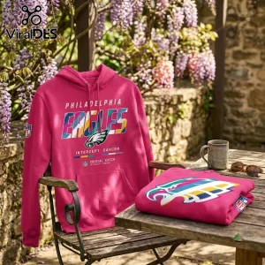 Philadelphia Eagles NFL Crucial Catch pink hoodie with multi-colored team graphics and Intercept Cancer text.