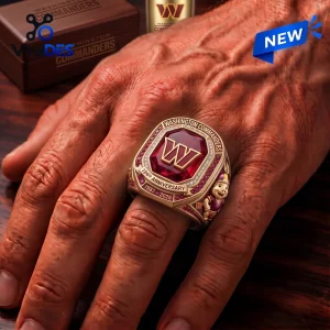 Closeup of a Washington Commanders ruby championship ring worn on a hand.