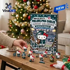 Hand placing a miniature figure near a Hello Kitty Philadelphia Eagles advent calendar in a festive room.